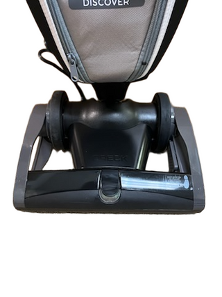 The image shows the base of a lightweight Oreck Discover vacuum cleaner standing upright, with the brand name "Imagine Sewing & Vacuum" clearly visible on the front.