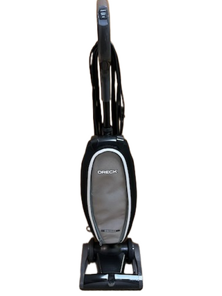 The Oreck Discover from Imagine Sewing & Vacuum, shown upright in gray and black on a white background, is a lightweight vacuum cleaner designed for effortless cleaning.