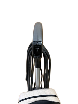 A close-up of an Oreck XL21 vacuum handle with cords wrapped, photographed on white. This refurbished Imagine Sewing & Vacuum model works efficiently on most floor types.