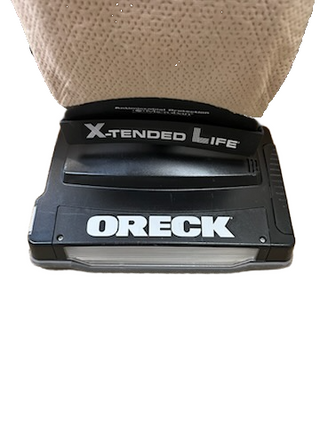 Close-up of the base of an Oreck XL21 vacuum from Imagine Sewing & Vacuum, featuring the brand name and "X-TENDED LIFE" label, ideal for cleaning most flooring.