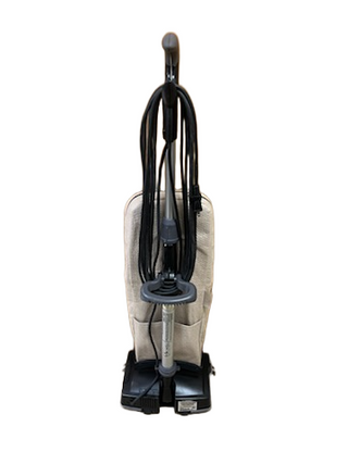 The refurbished Imagine Sewing & Vacuum Oreck XL21 upright vacuum features a beige bag, black power cord coiled on the handle, and delivers powerful cleaning on most flooring types, shown against a white background.
