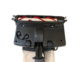 Bottom view of a refurbished Imagine Sewing & Vacuum Oreck XL21 vacuum head with brush rollers, central black belt, and beige dust bag—great for cleaning most floor types.