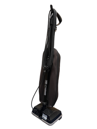 The Sew & Vac certified refurbished Oreck XL upright vacuum features a dark body with a coiled power cord hanging from the handle.