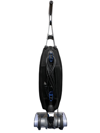 The Oreck Magnesium by Sew & Vac is an upright vacuum with a black body, coiled cord, and blue accents, ideal for hard floors, set against a white background.