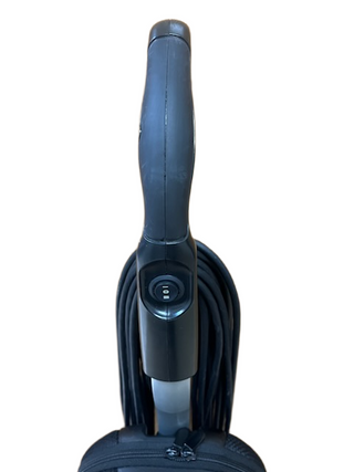 Black Riccar R10P vacuum cleaner handle with an attached cord wrapped around the back, photographed against a white background. This lightweight, refurbished vacuum from Imagine Sewing & Vacuum offers reliable performance and easy operation.