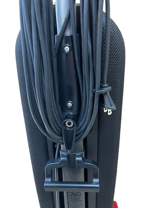 The Riccar R10P vacuum cleaner by Imagine Sewing & Vacuum is shown from the back, featuring its lightweight design and a power cord neatly wrapped around the built-in hooks.
