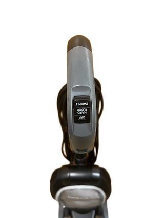 Top view of an Imagine Sewing & Vacuum Oreck Discover lightweight vacuum cleaner handle with a switch labeled “OFF HAND CARPET FLOOR” against a plain white background.