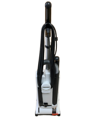 A refurbished Sebo X4 upright vacuum cleaner viewed from the back, with a power cord coiled around the handle.