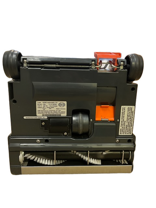 Underside of a refurbished Sebo X4 vacuum cleaner showing the rotating brush roll and wheels.