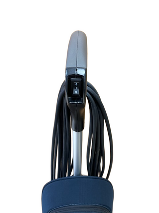 Top section of an Oreck XL Gold lightweight, two-speed vacuum handle featuring an on-off power switch and a wrapped black power cord.