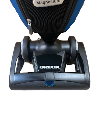 Close-up view of an Oreck Magnesium LW100 vacuum cleaner nozzle with wheels and a central logo.