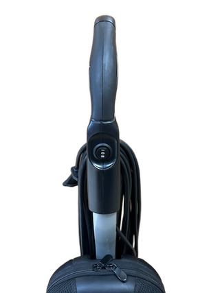 Riccar R10P upright vacuum cleaner handle with a power switch and coiled black power cord.