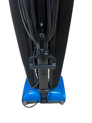 Back view of a blue Riccar R10P upright vacuum cleaner with its power cord wrapped around the handle hooks.