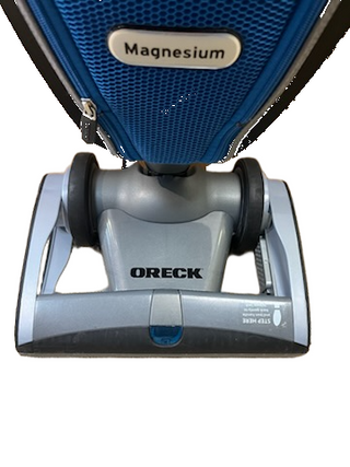 Refurbished Oreck Magnesium vacuum cleaner base with a blue fabric bag attachment.