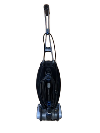 Refurbished Oreck Magnesium upright vacuum cleaner with a black bag and a long power cord coiled around the handle.