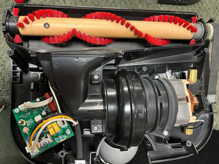 Interior of a Oreck Elevate Conquer vacuum cleaner showing the HEPA CC bag, motor, and circuit board.