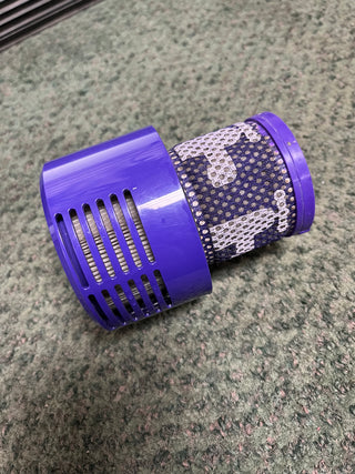 A purple cylinder with a blue and white fabric on it, Sew & Vac Dyson Cyclone v10 Animal demo vacuum.