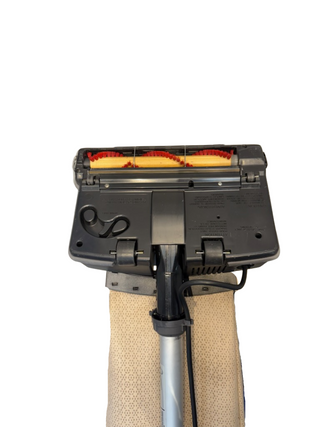 The underside of the Oreck XL21 refurbished vacuum cleaner by Imagine Sewing & Vacuum displays the brush roll, belt, and base plate against a white background.