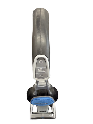 A top-down view of the Oreck Magnesium LW1500 handle by Imagine Sewing & Vacuum, showing power and "low"/"high" speed buttons and a new brushroll for improved cleaning.