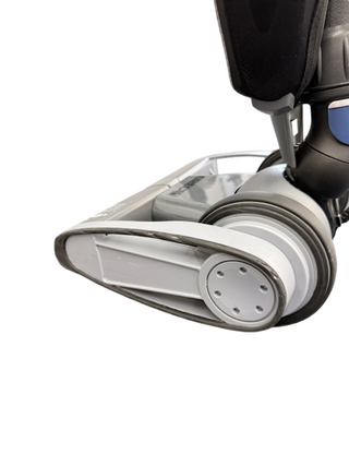 Close-up of the base and rotating brushroll on the Imagine Sewing & Vacuum Oreck Magnesium LW1500 upright vacuum cleaner against a white background.