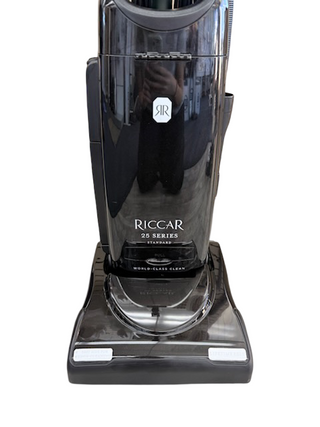 A black Riccar R25 Standard upright vacuum by Imagine Sewing & Vacuum, featuring a self-adjusting brushroll and “World-Class Clean” on the base, is shown against a white background.