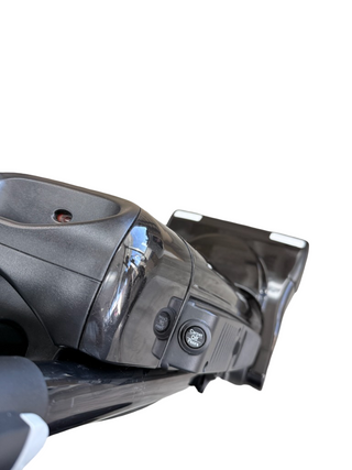 Close-up of the Riccar R25 Standard vacuum head by Imagine Sewing & Vacuum on a white background, highlighting the Carpet/Floor switch, part of the handle, and lifetime belt protection for added durability.