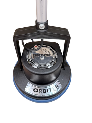 Close-up of the Oreck Orbiter floor cleaner by Imagine Sewing & Vacuum, highlighting the handle and round cleaning head against a white background.