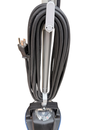 The Oreck Orbiter from Imagine Sewing & Vacuum has its power cord neatly wound around the handle hooks.