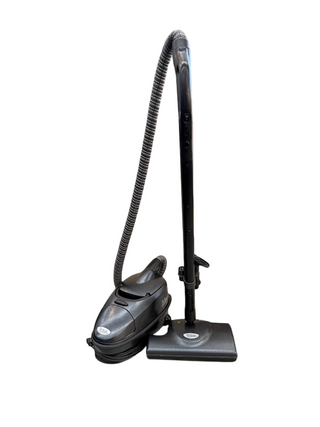 The Imagine Sewing & Vacuum TriStar CS Canister, shown in black with hose and floor tool on a white background, delivers powerful suction for efficient cleaning.