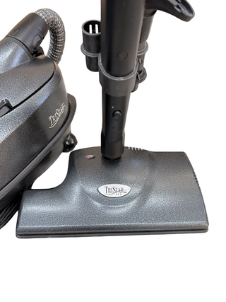 A close-up of the Imagine Sewing & Vacuum TriStar CS Canister lightweight vacuum cleaner, featuring its base and part of the handle against a white background.