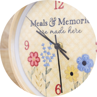 Close-up of a floral clock face with "Meals & Memories are made here"—an ideal muse for cottagecore embroidery or your next Layton In-Store Class: Kimberbell "Just Add Butter" 1-Day In-Person Only Event on February 28, 2026. Clock shows 8:00.