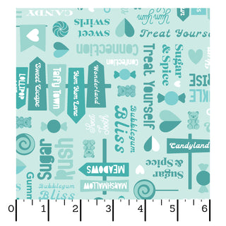 Kimberbell Maywood Studios Sweet Shoppe Sweet Streets Blue MAS11023-B fabric features candy-themed words in white and teal on light blue. Shown with a ruler for scale, it's perfect for sweet, candy-inspired quilting cotton projects. Brand: Maywood Studios.