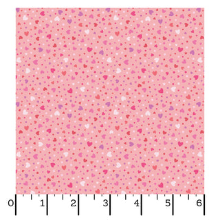 Kimberbell Maywood Studios Sweet Shoppe Hearts Pink MAS11028-P fabric by Maywood Studios features a candy-inspired heart pattern in pink, red, and white on quilting cotton, shown with a ruler for scale.