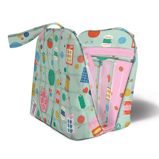 Join the Layton In-Store "Truvy Bag Class with Carla" on 10/25/25 from 1–5 pm to sew a zippered organizer with a wrist strap and colorful sewing-themed illustrations on light green, featuring a pink interior.