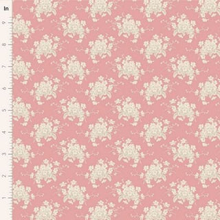 The Tilda Sunday Brunch WHITE FLOWER PINK TIL100591 fabric by Riley Blake features romantic cream florals on pink, shown with a vertical inch ruler—ideal for premium quilting cotton projects.