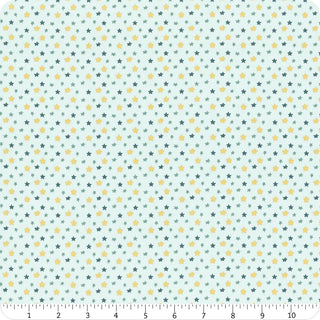 The Riley Blake Baby Boy Stars Blue C16766-BLUE Fabric by Lori Whitlock features a pale blue background with small green and yellow stars, ideal for baby boy projects. Includes a ruler on the bottom showing measurements from 0 to 12 inches.