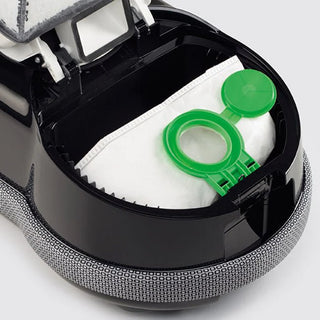 Close-up of the Sebo Airbelt D4 Premium Onyx by 27-Sebo, highlighting its open compartment with a white dust bag featuring a green plastic closure and advanced filtration for ultra-quiet cleaning.