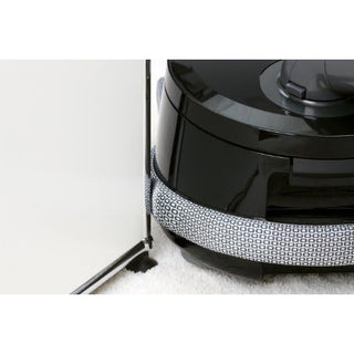 The 27-Sebo Sebo Airbelt D4 Premium Onyx, a black vacuum with advanced filtration and a patterned bumper, moves near the edge of a carpet and wall corner.