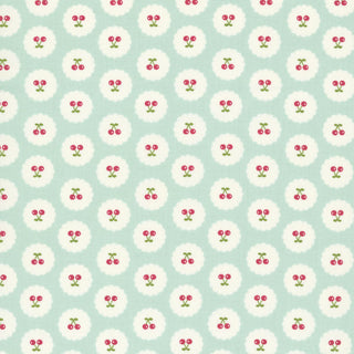 Featuring a repeating pattern of small red cherries with green stems inside white circles on a light blue background, the Minki Kim Cotton Nook Cherries Bleached Denim C17973-BLEACHEDDENIM by 56-Riley Blake is perfect for keepsake sewing and quilts inspired by nostalgic prints.