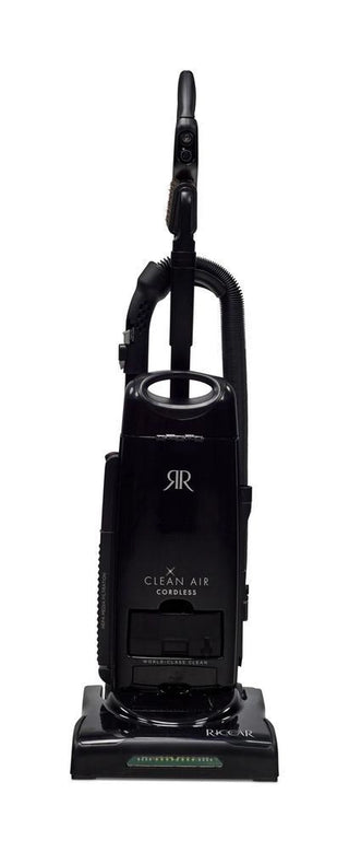 The Imagine Sewing & Vacuum Riccar R27CV Cordless Upright Vacuum, featuring HEPA filtration, a handle, hose, and visible control buttons in black, is photographed against a white background.