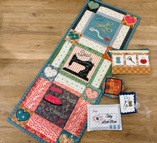 Join us for the Riley Blake Embroidery Event on September 12th from 10 am to 6 pm at our Layton location only! Admire a vibrant quilted table runner and four charming small zippered pouches, each featuring sewing-themed embroidery designs—beautifully displayed on a wooden floor and crafted with care. Presented by 1000-Education.