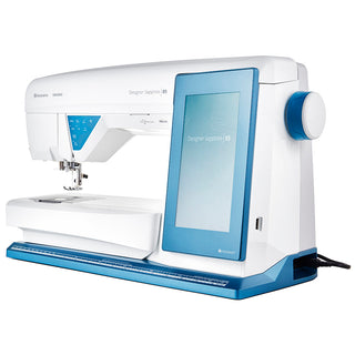 The Husqvarna Viking Designer Sapphire 85 is a white and blue embroidery machine with a large digital touchscreen, featuring advanced mySewnet™ connectivity for easy design transfers.