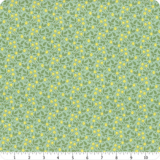 Tilda Sunday Brunch Blender TIPSY TEAL TIL110115 by Fabric by Tilda features green fabric with small yellow flowers and green leaves. A ruler at the bottom edge shows scale, evoking vintage summerhouse charm.