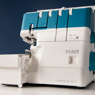 A PFAFF sewing machine with a blue and white color.
