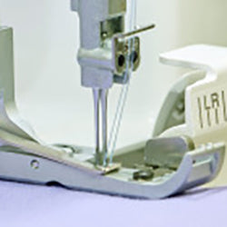 A Baby Lock Acclaim Serger is being used to sew a piece of fabric.