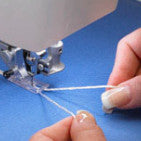 A person using a Baby Lock Sashiko Specialty Machine to sew a piece of fabric.