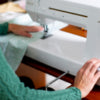 A woman is sewing on a Baby Lock Jazz II Sewing and Quilting Machine.
