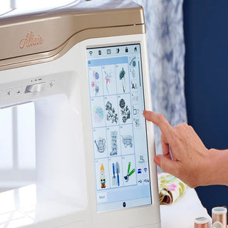 A person is using a Baby Lock Altair Sewing & Embroidery Machine with an ipad.