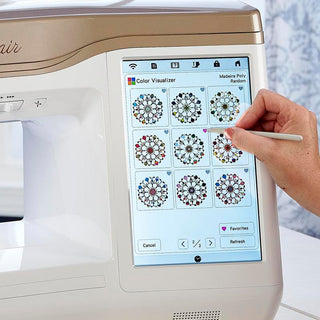 A person using a Baby Lock Altair Sewing & Embroidery Machine with a touch screen.