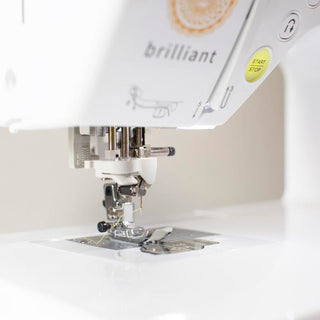A close up of a white Baby Lock Brilliant Sewing Machine.